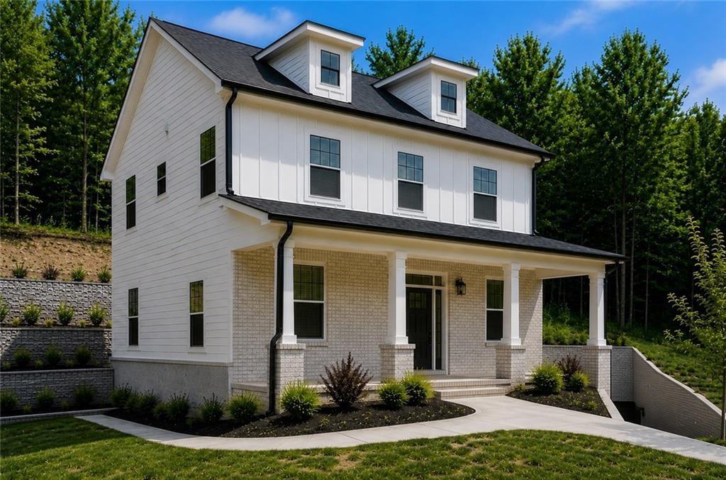 Two-story white house with a covered porch, twin dormers, and landscaped front walkway.