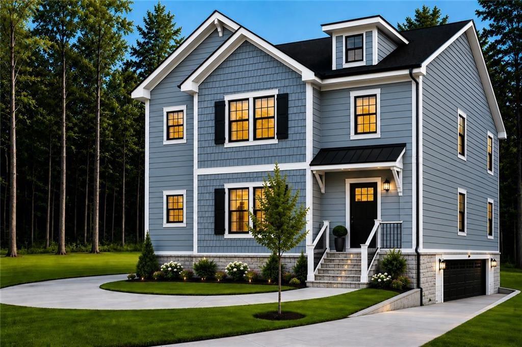 Blue-gray two-story house with white trim, black shutters, landscaped lawn, and an attached garage.
