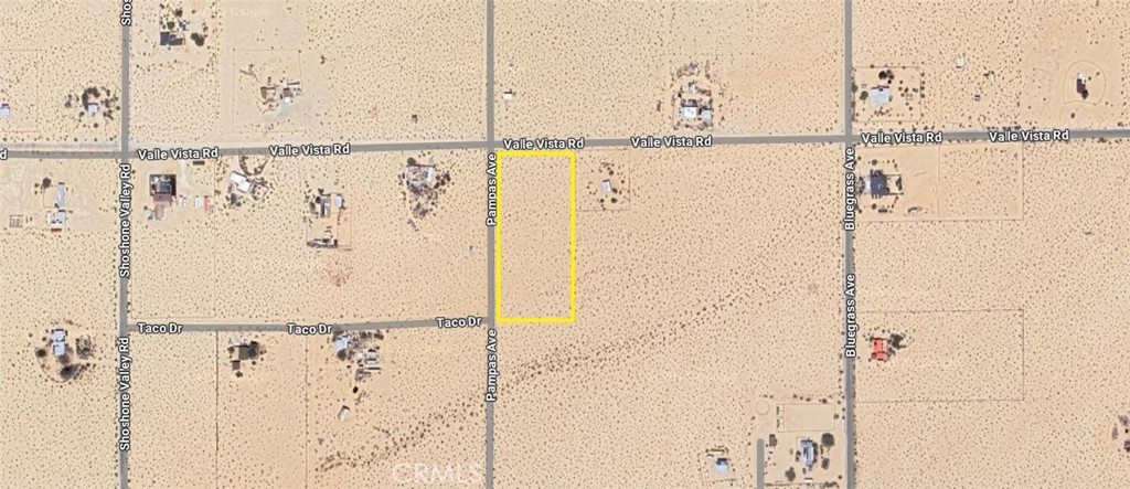 Vacant desert parcel outlined in yellow along Pamosas Avenue, between Valle Vista Road and Taco Drive.