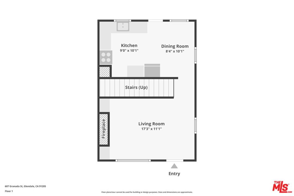 First-floor plan showing the kitchen, dining room, living room, stairs, fireplace and entry.