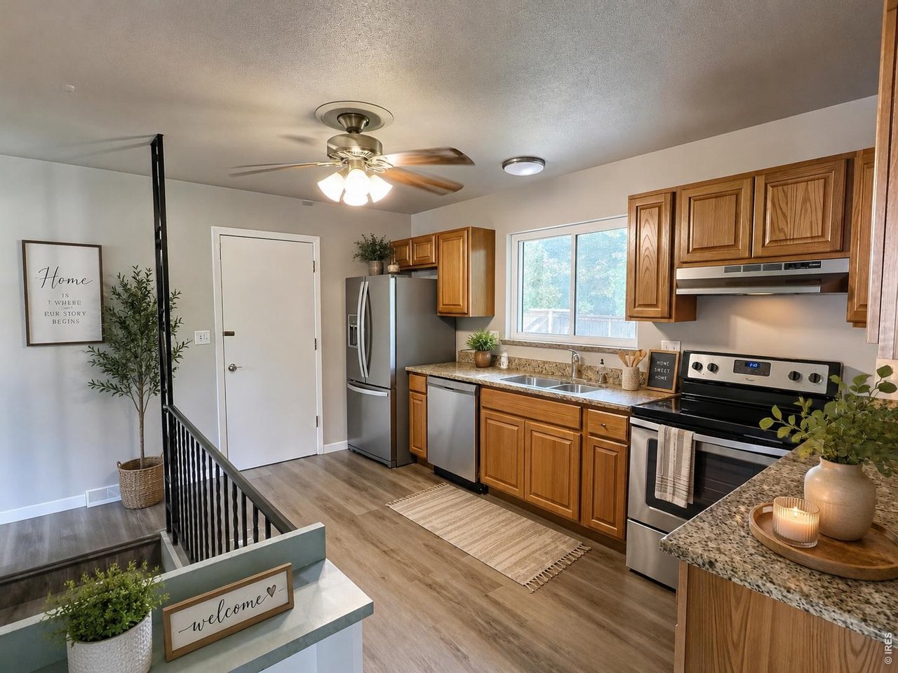 Kitchen with oak cabinets, granite counters, stainless steel appliances, and a sink beneath the window.