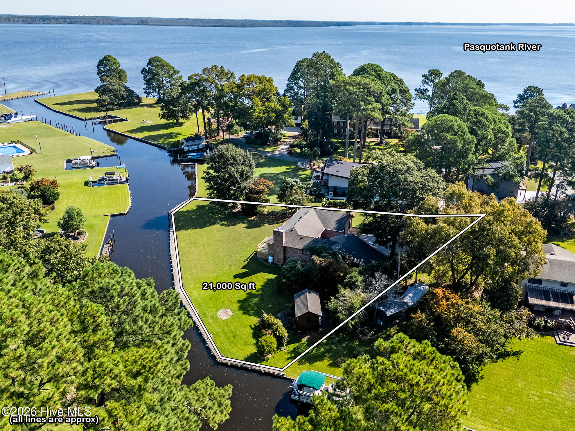 Aerial view of a waterfront home and outlined 21,000-square-foot lot beside the Pasquotank River.