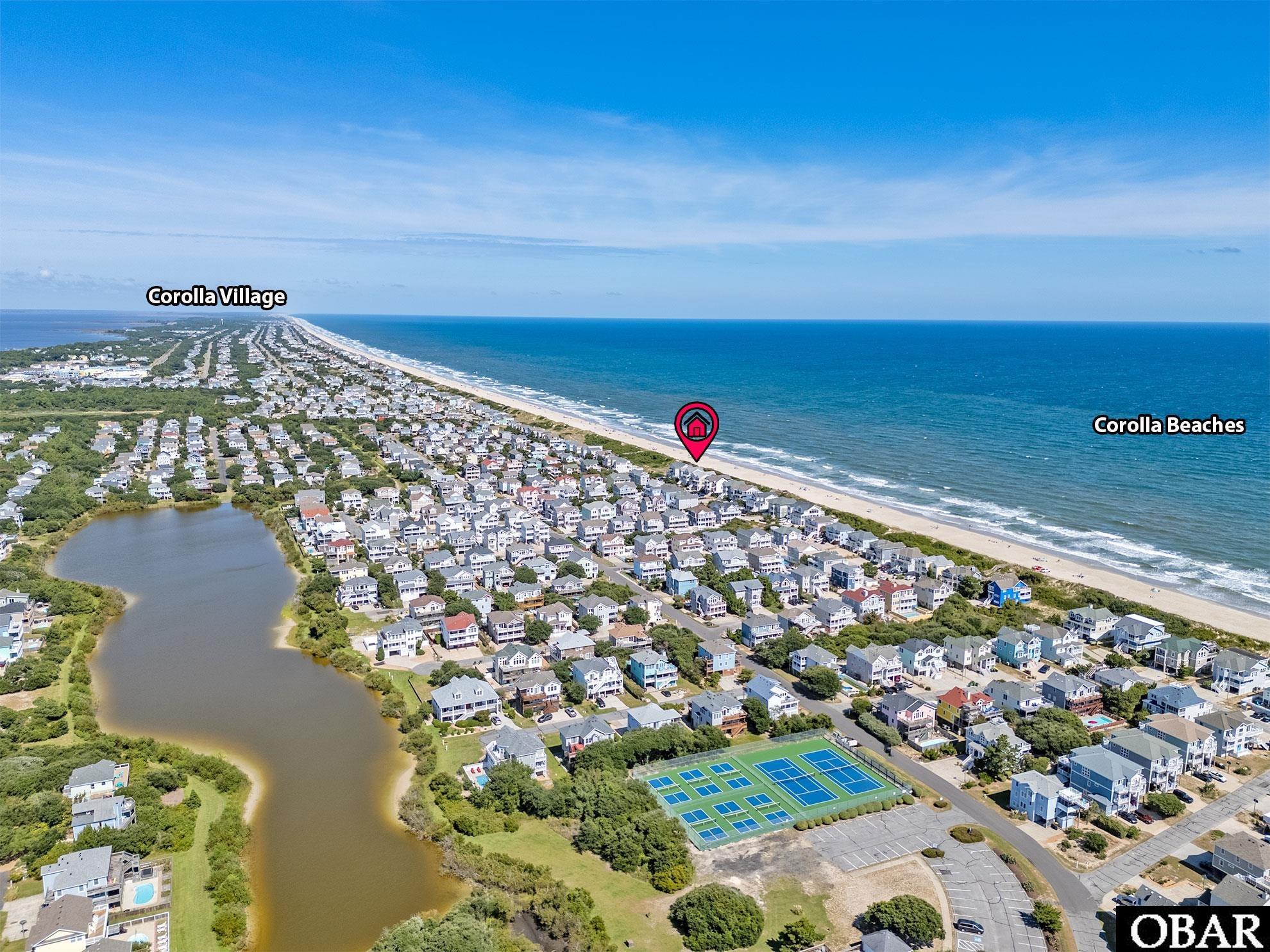 Aerial view of Corolla’s beachfront neighborhood, with the property marked near the shoreline.