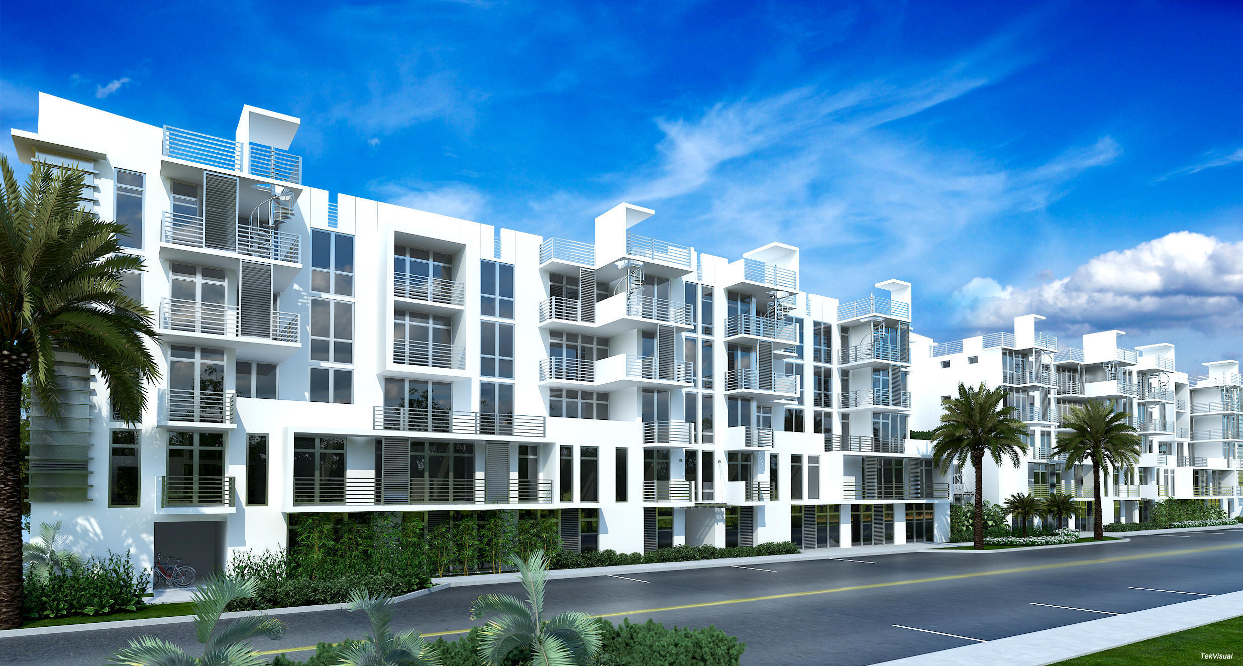 Modern white condominium building with glass balconies, rooftop terraces, and palm trees.