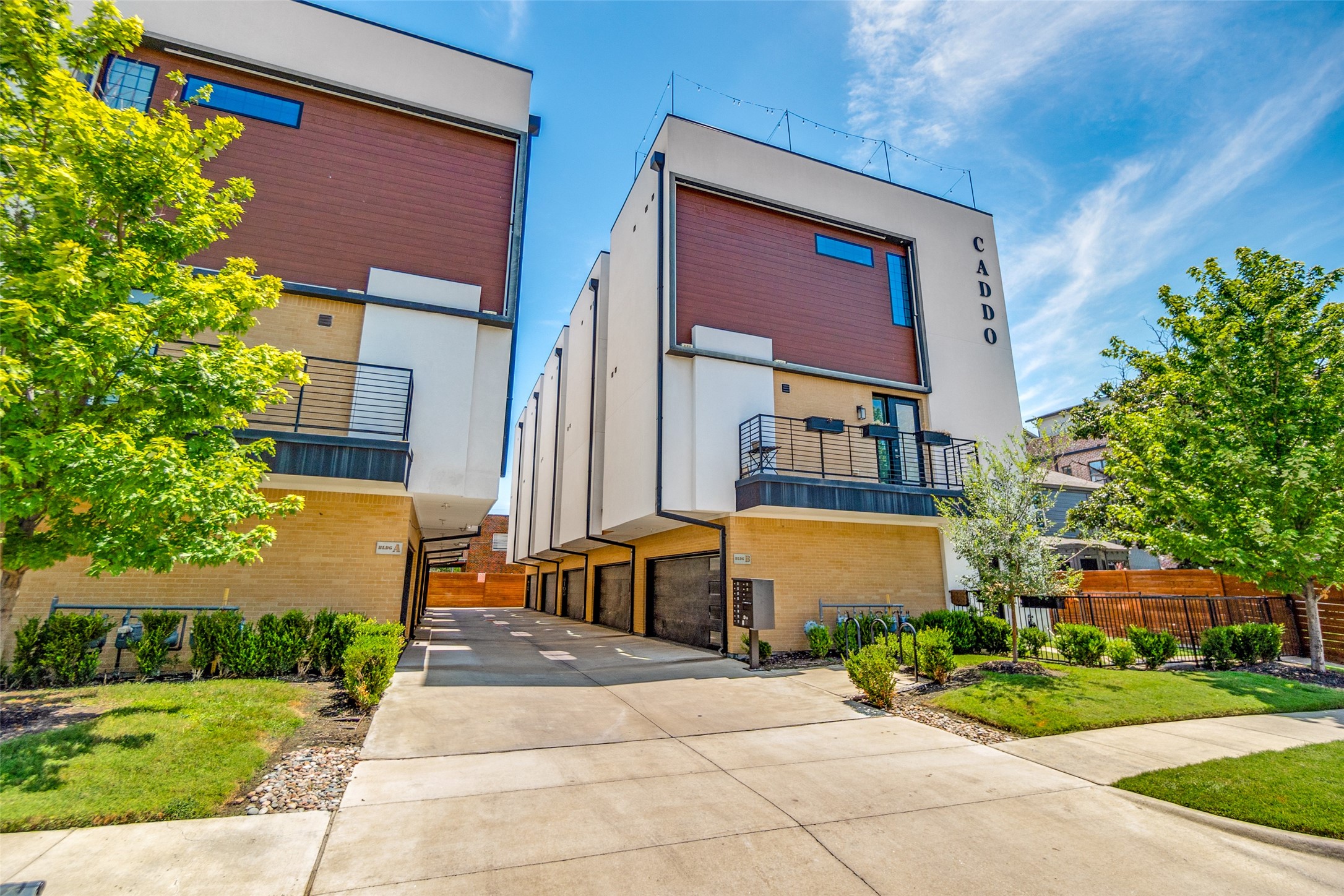 Contemporary CADDO residences with balconies, garage entrances, and landscaped lawns.