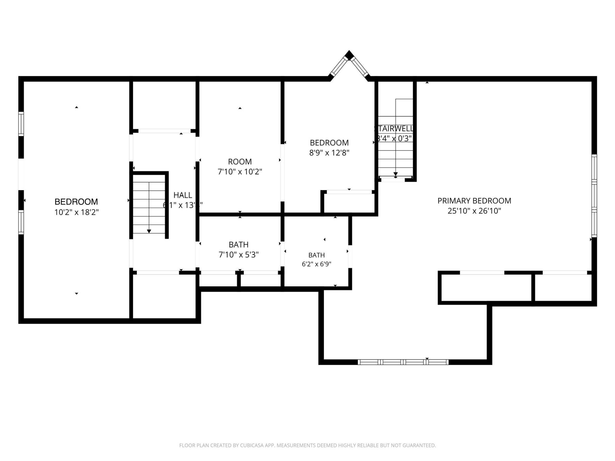 Floor plan showing a primary bedroom, two bedrooms, a room, hall, bathrooms, and stairwells.