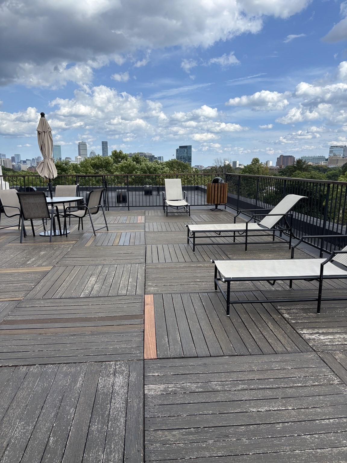 Rooftop deck with lounge seating and a broad Boston skyline view.