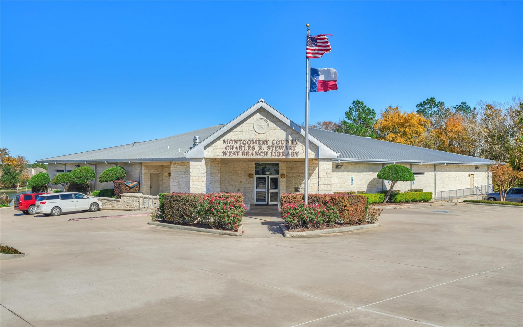 Montgomery County Charles B. Stewart West Branch Library, with American and Texas flags above the entrance.