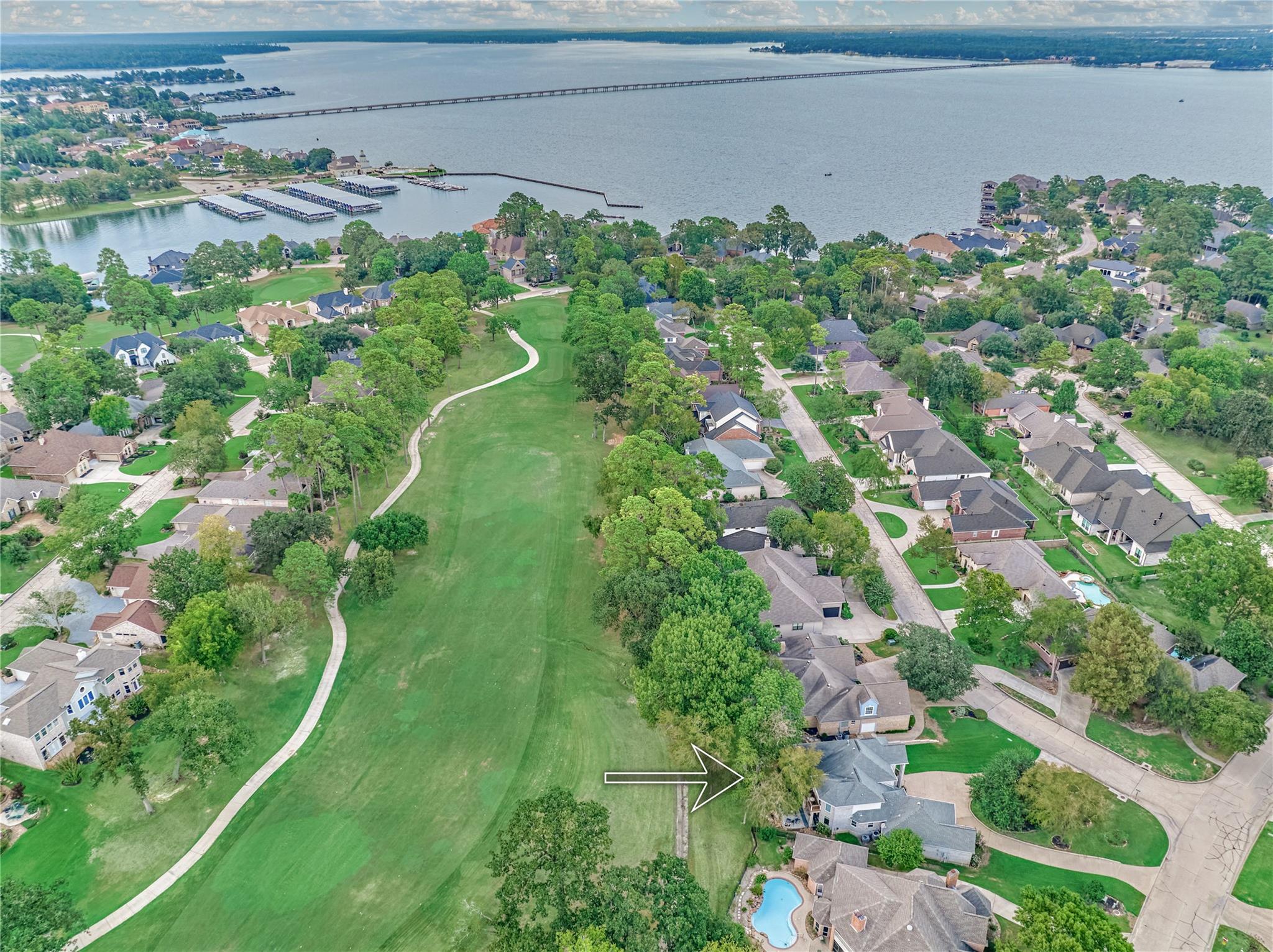 Aerial view of 3 Melrose Drive, marked by an arrow beside a broad green open space.