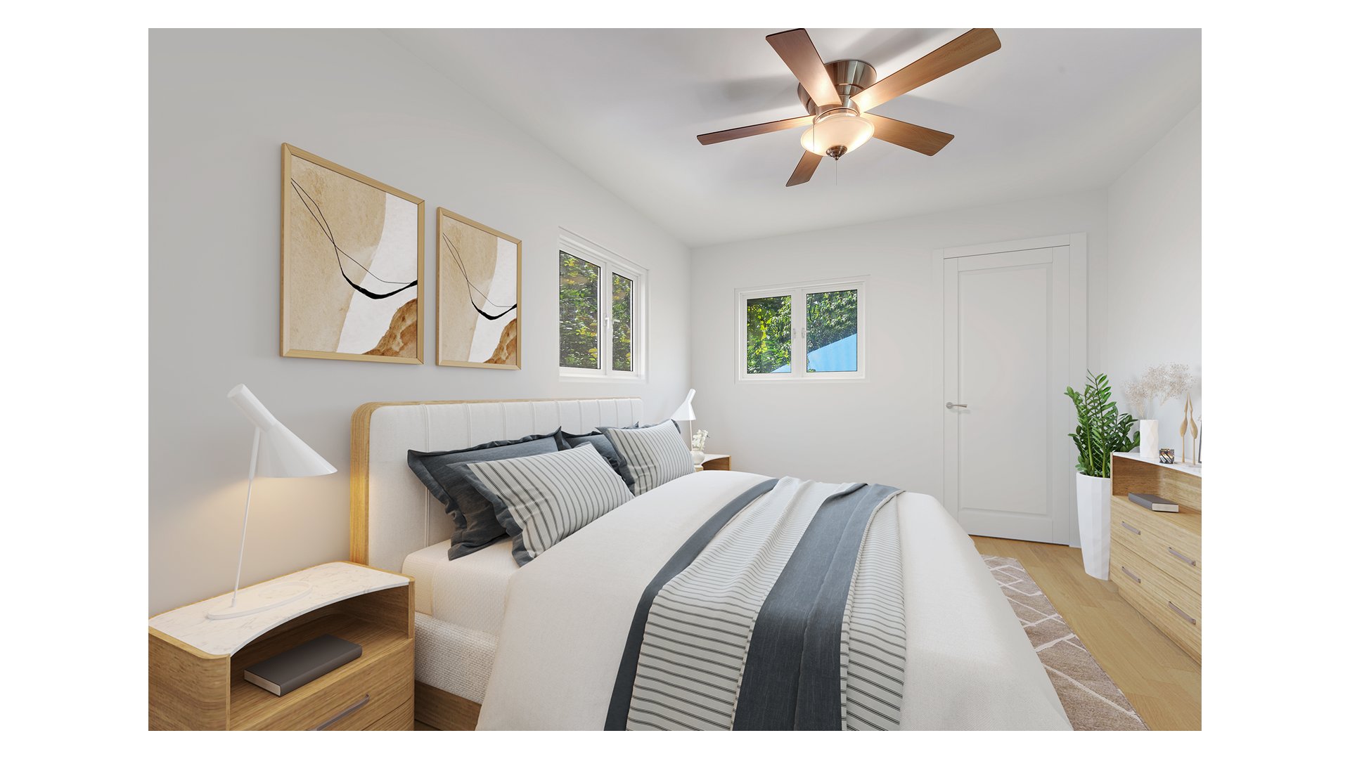Bright bedroom with a large bed, gray striped bedding, abstract wall art, and a wood-bladed ceiling fan.
