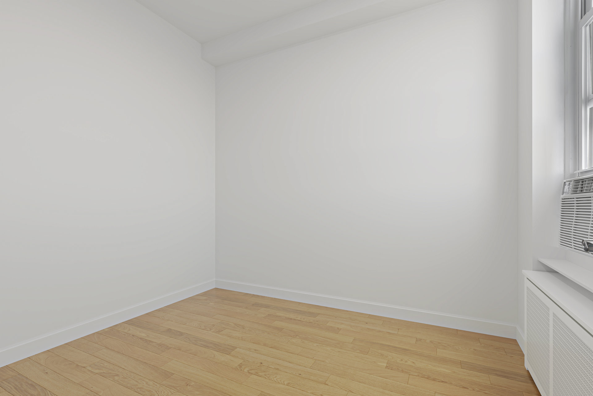 Empty room with light wood floors, a window air conditioner, and a built-in radiator cover.