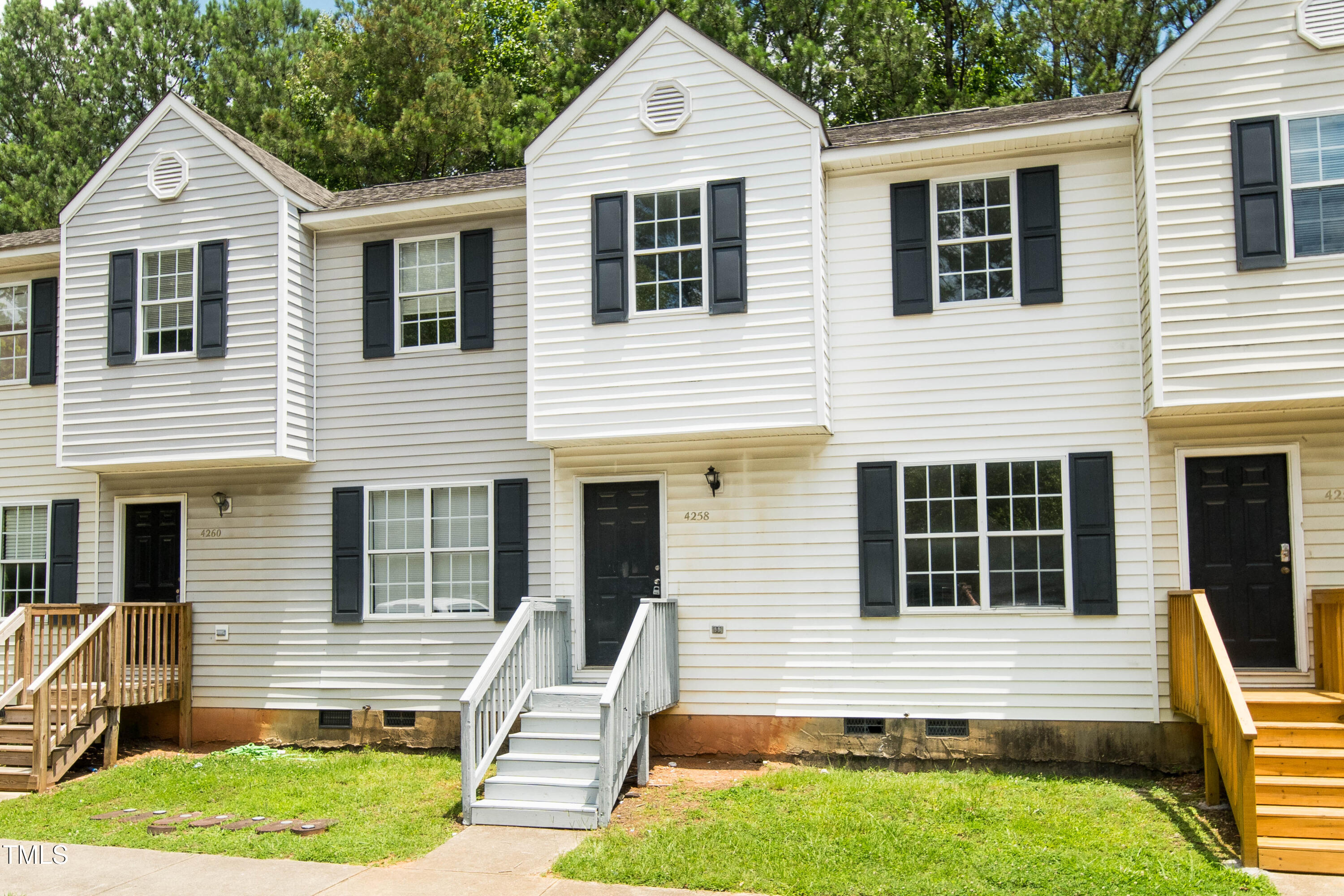 Townhouse at 4258 Kaplan Drive with white siding, black shutters, and a white front staircase.