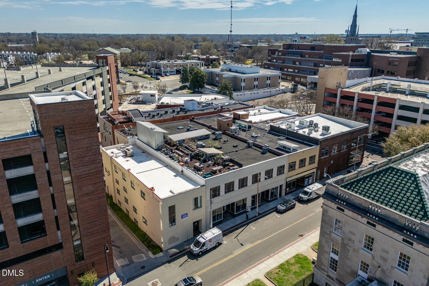 Aerial view of a downtown building with flat rooftops and surrounding city blocks.