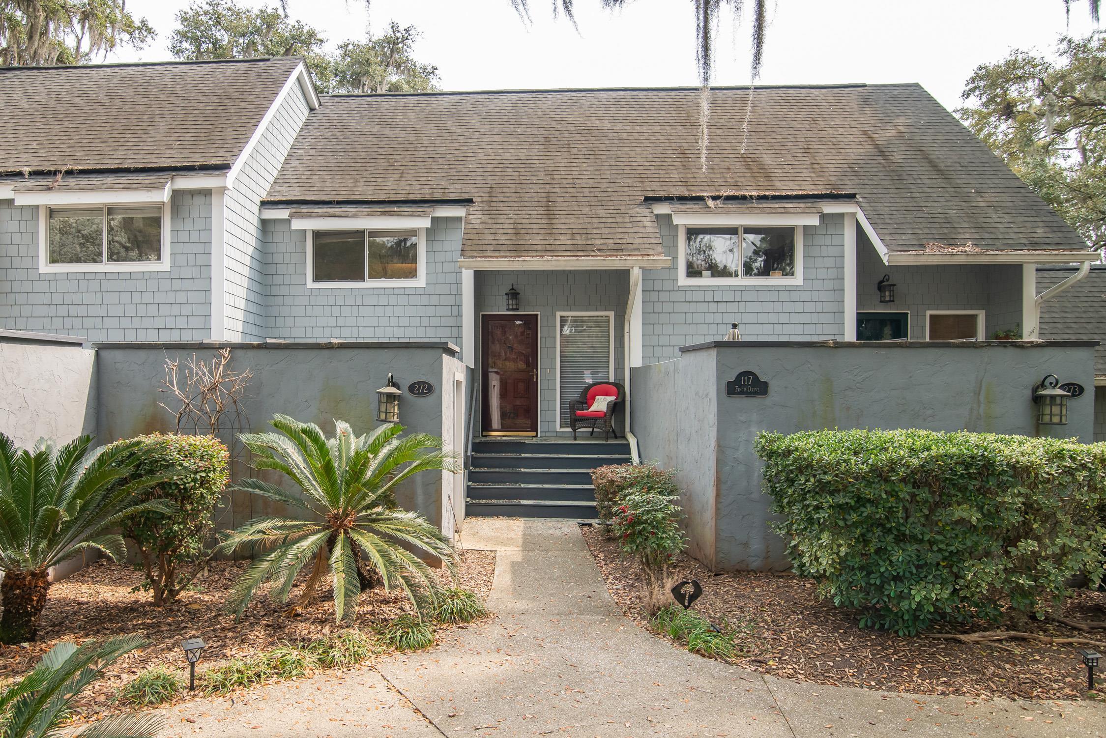 Home at 117 Finch Drive with a walled entry path, front steps, and a red chair on the porch.