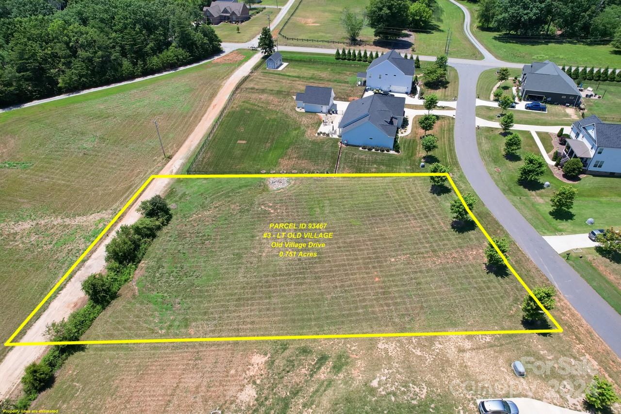 Aerial view of a vacant Old Village Drive lot outlined in yellow beside a residential neighborhood.
