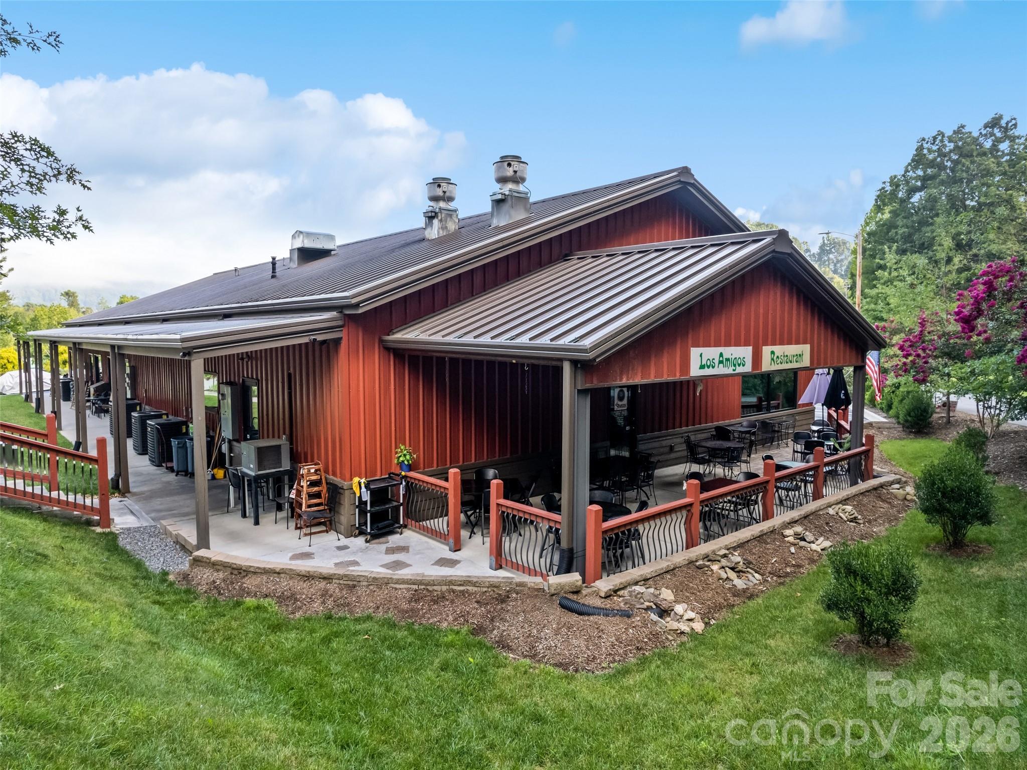 Los Amigos Restaurant exterior with a metal roof and covered outdoor dining patio.