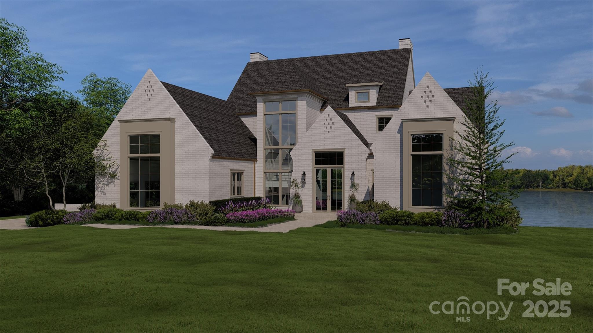 White brick home with steep dark roofs and tall windows beside a lake, framed by a landscaped lawn.