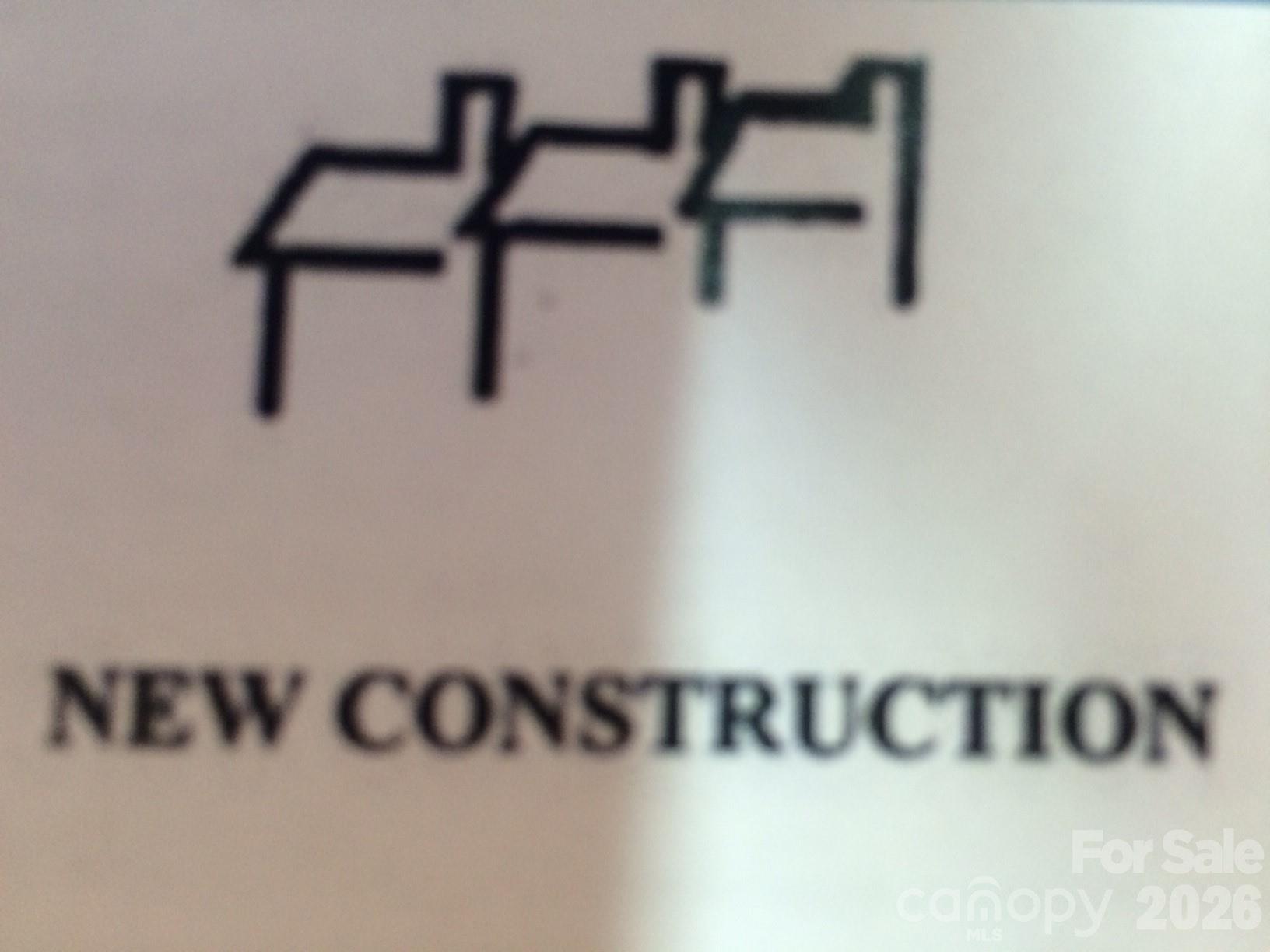New construction sign graphic with three overlapping house outlines.