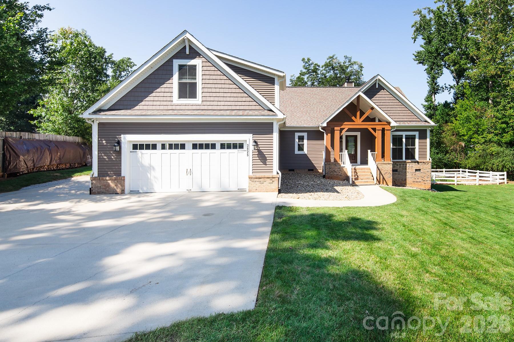 House number 3825, with a timber-trimmed covered entry, brick accents, and a wide driveway.