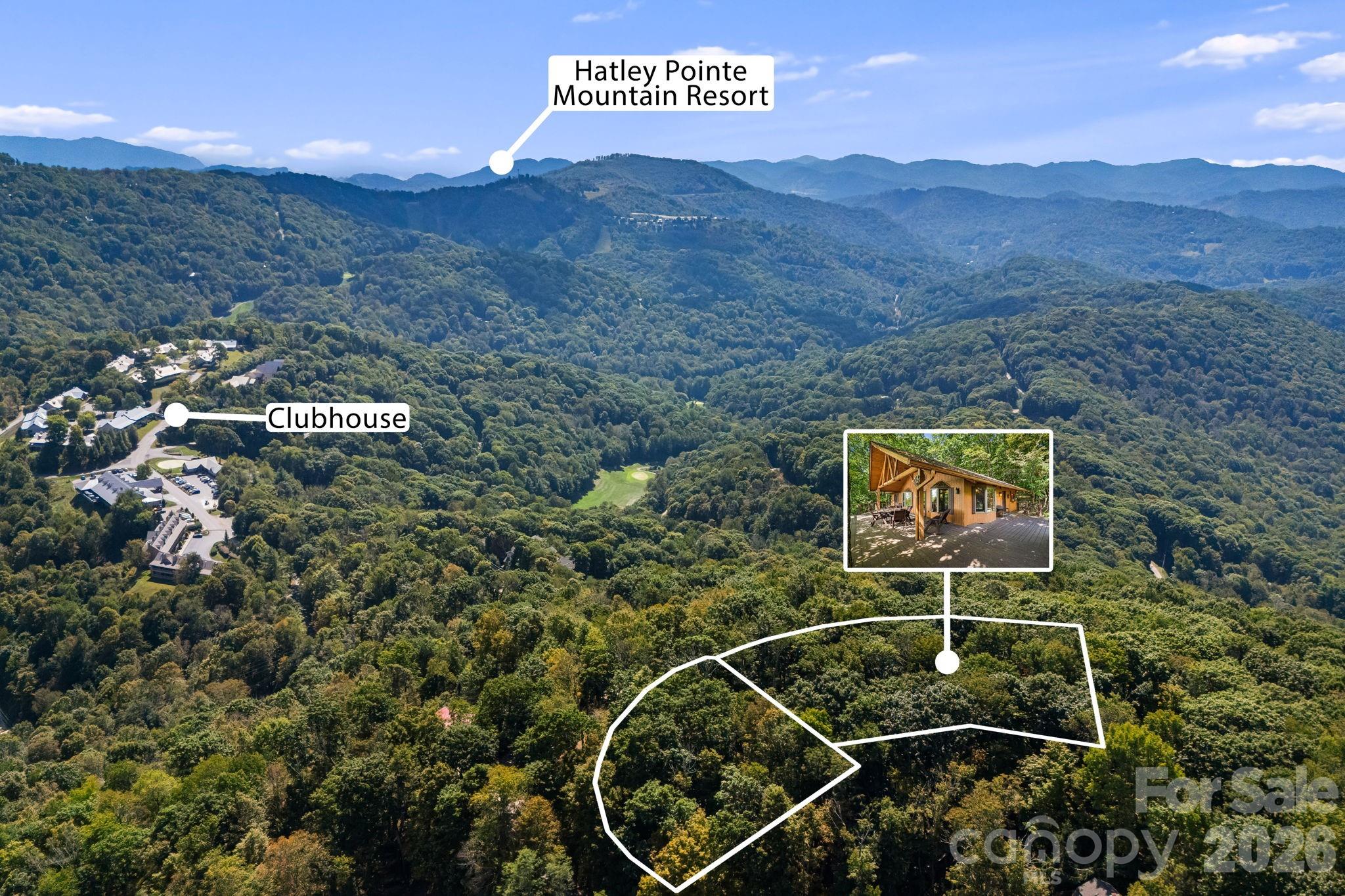 Wooded mountain parcel outlined near Hatley Pointe Mountain Resort, with a cabin inset and clubhouse nearby.
