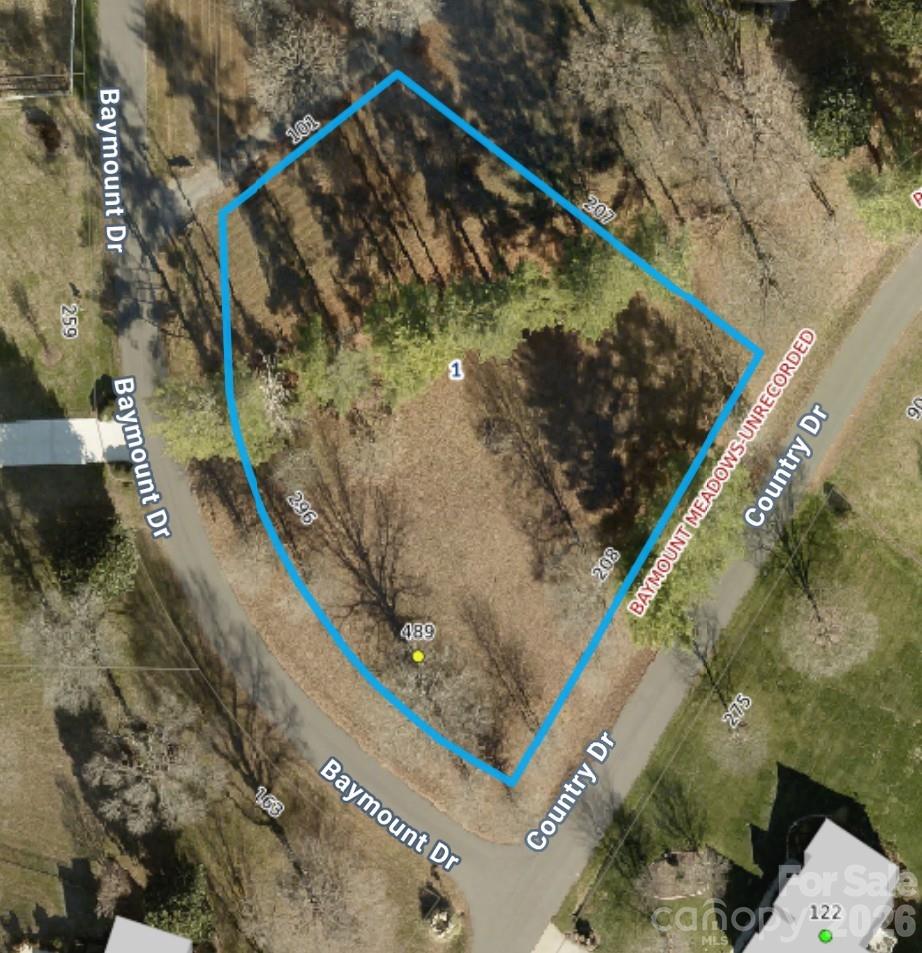 Aerial view of the tree-covered corner lot at 489 Baymount Drive, outlined in blue.