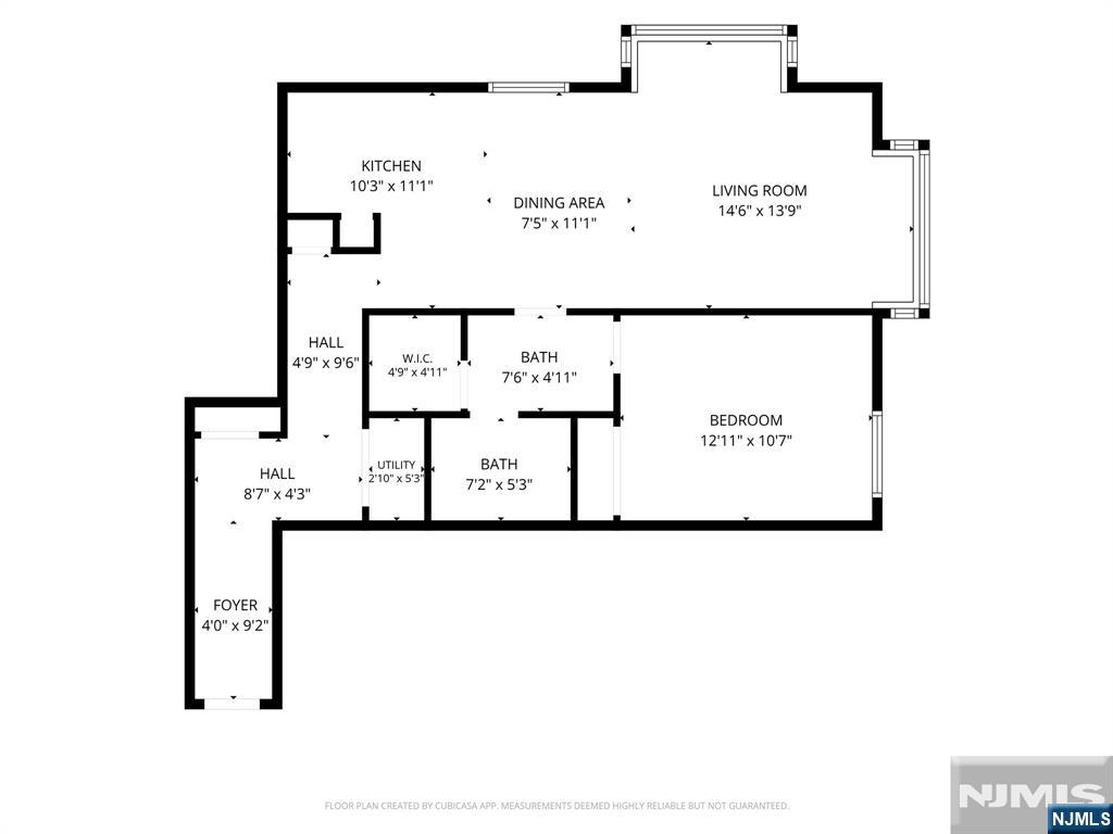 Floor plan of a one-bedroom home with two baths, a walk-in closet, and labeled room dimensions.