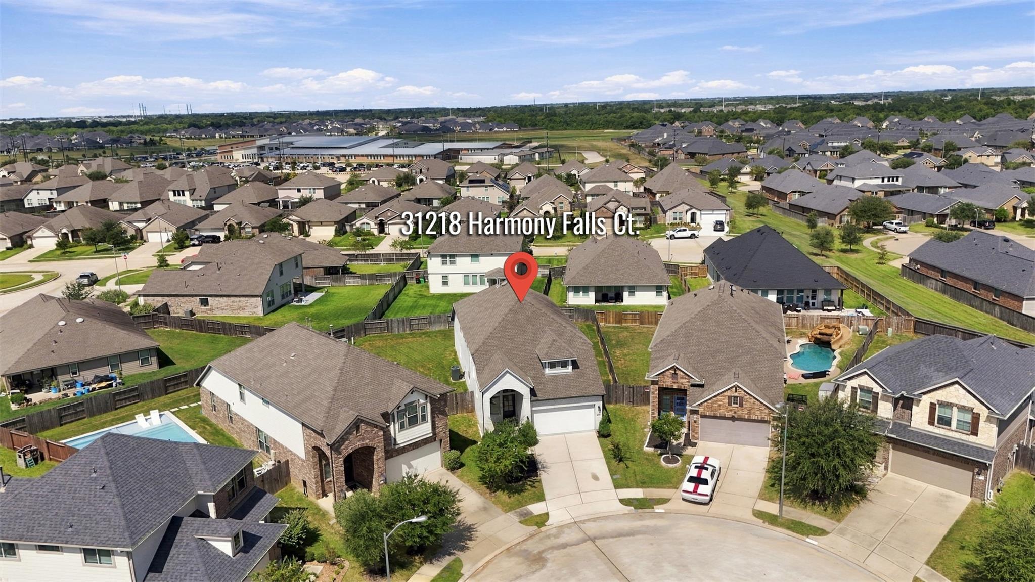 Aerial view of 31218 Harmony Falls Court, marked among neighboring homes in a suburban subdivision.