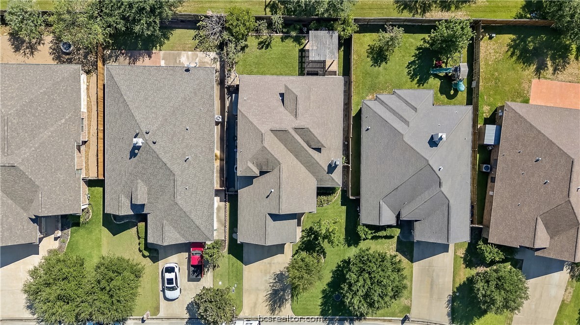 Aerial view of homes along Rock Bend Drive, with rooftops, driveways, and fenced backyards.