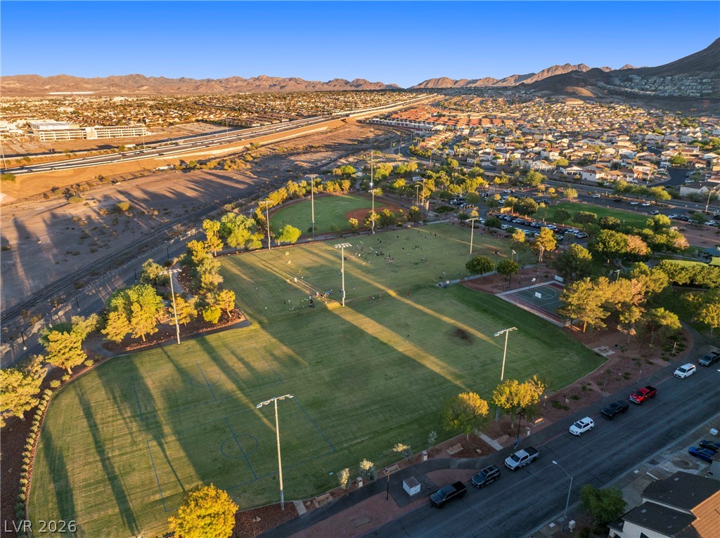 Aerial view of community sports fields, with surrounding neighborhoods and mountains in the distance.