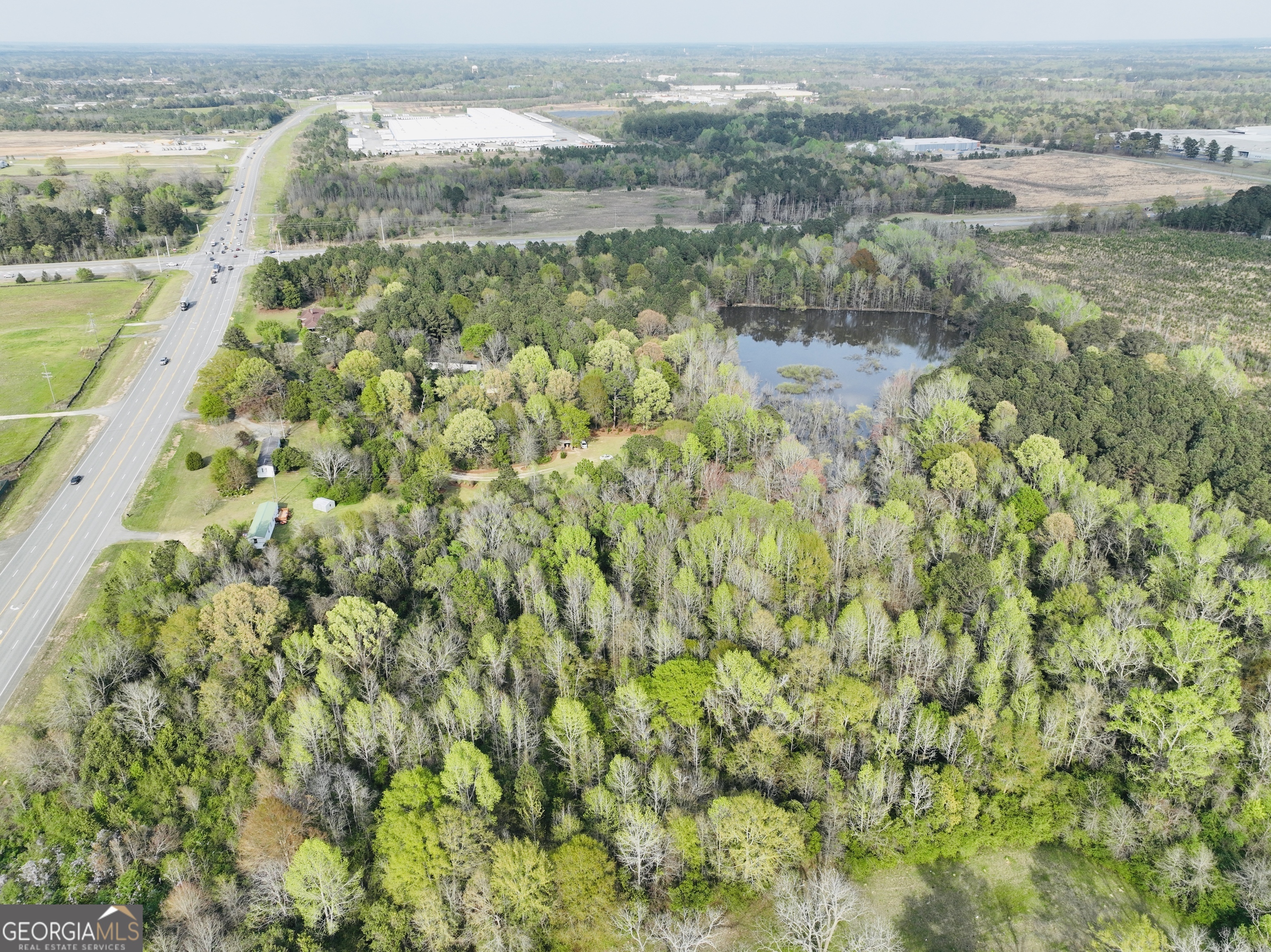 Aerial view of wooded land with a pond beside Georgia Highway 257.