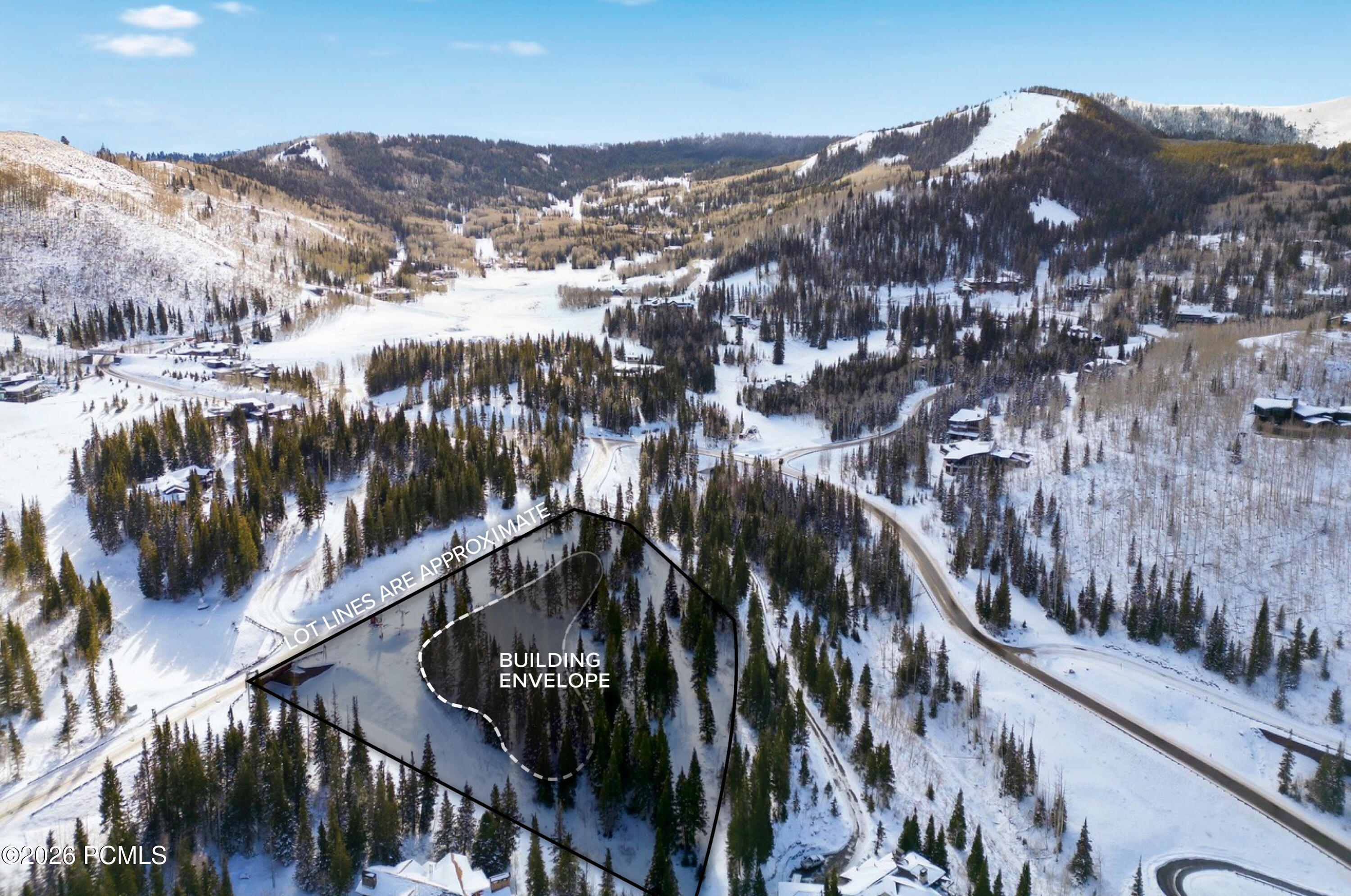 Snow-covered mountain parcel outlined with approximate lot lines and a marked building envelope.
