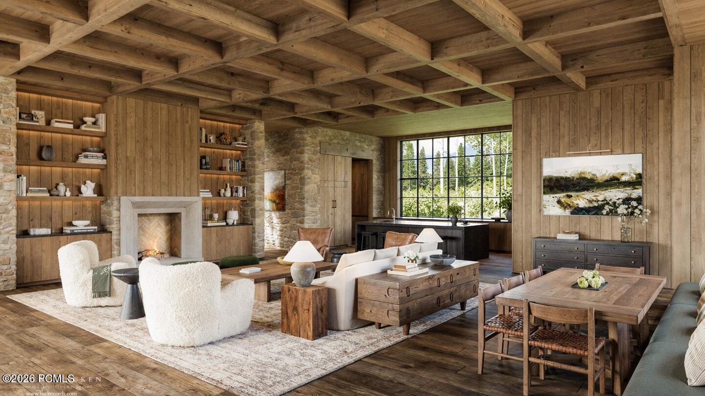 Open-plan living and dining room with a stone fireplace, timber ceiling, and large windows overlooking trees.