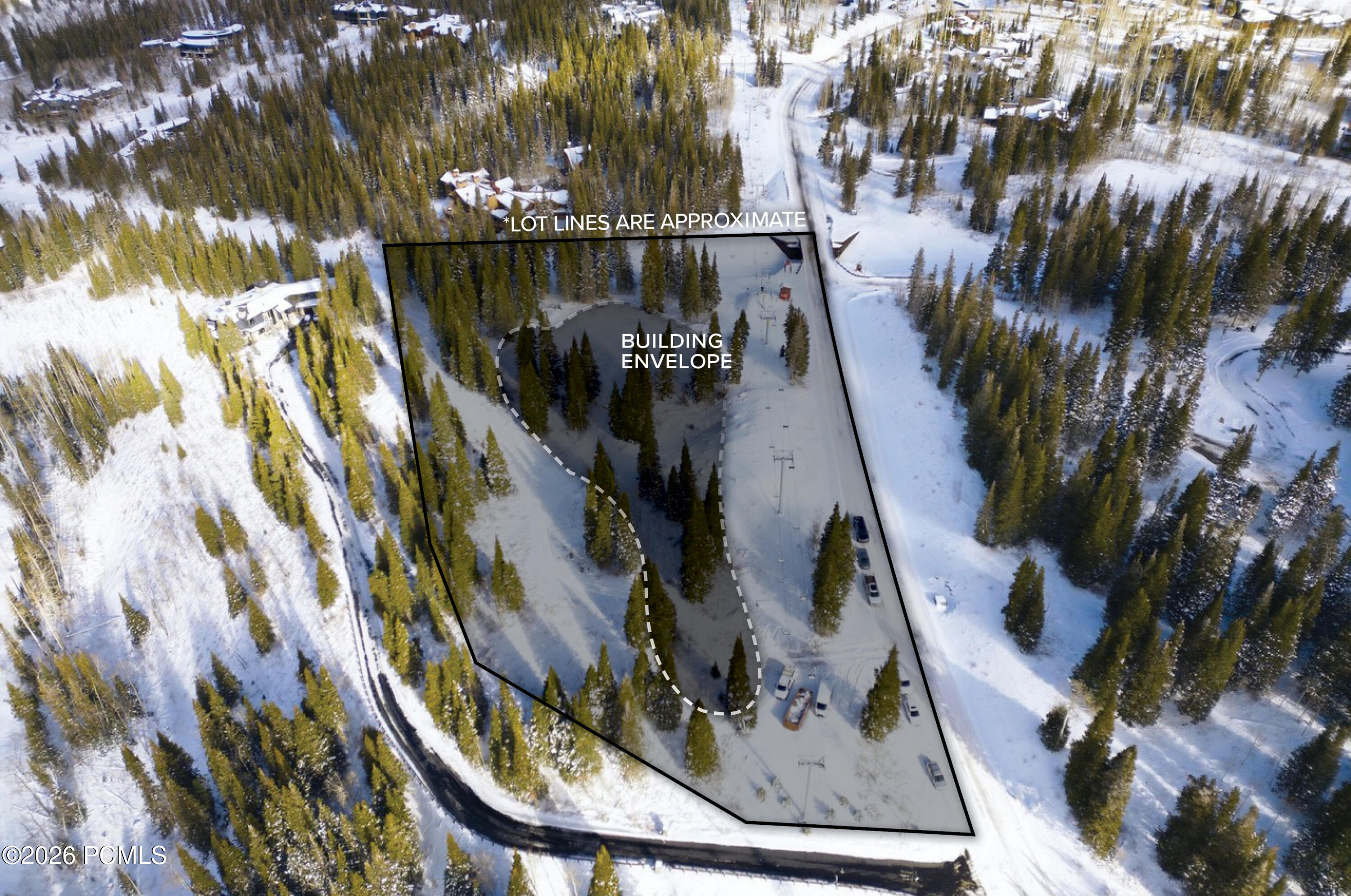 Snow-covered wooded lot outlined from above, with its building envelope marked among the trees.