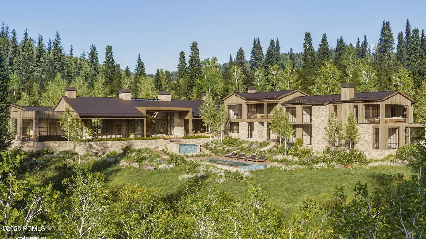Modern stone-and-timber mountain home with a pool and landscaped grounds, surrounded by evergreen trees.