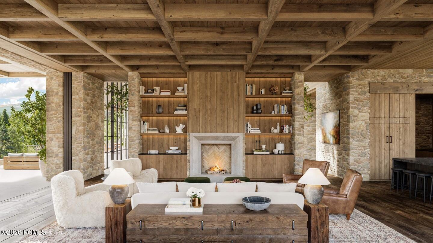 Living room with stone fireplace, built-in shelves, and exposed timber ceiling beams.