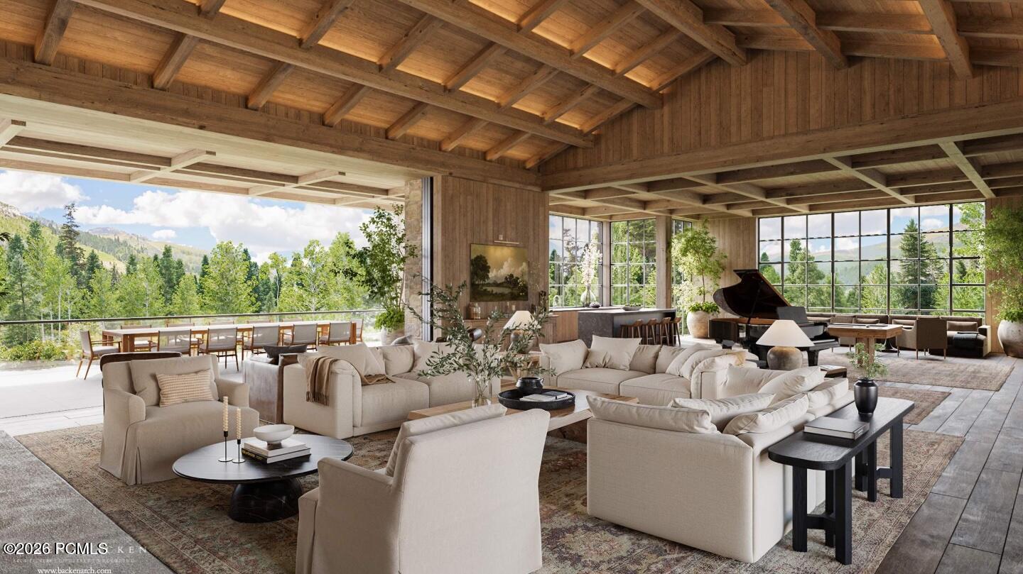 Great room with exposed timber ceiling, pale sofas, grand piano, and mountain views through expansive windows.