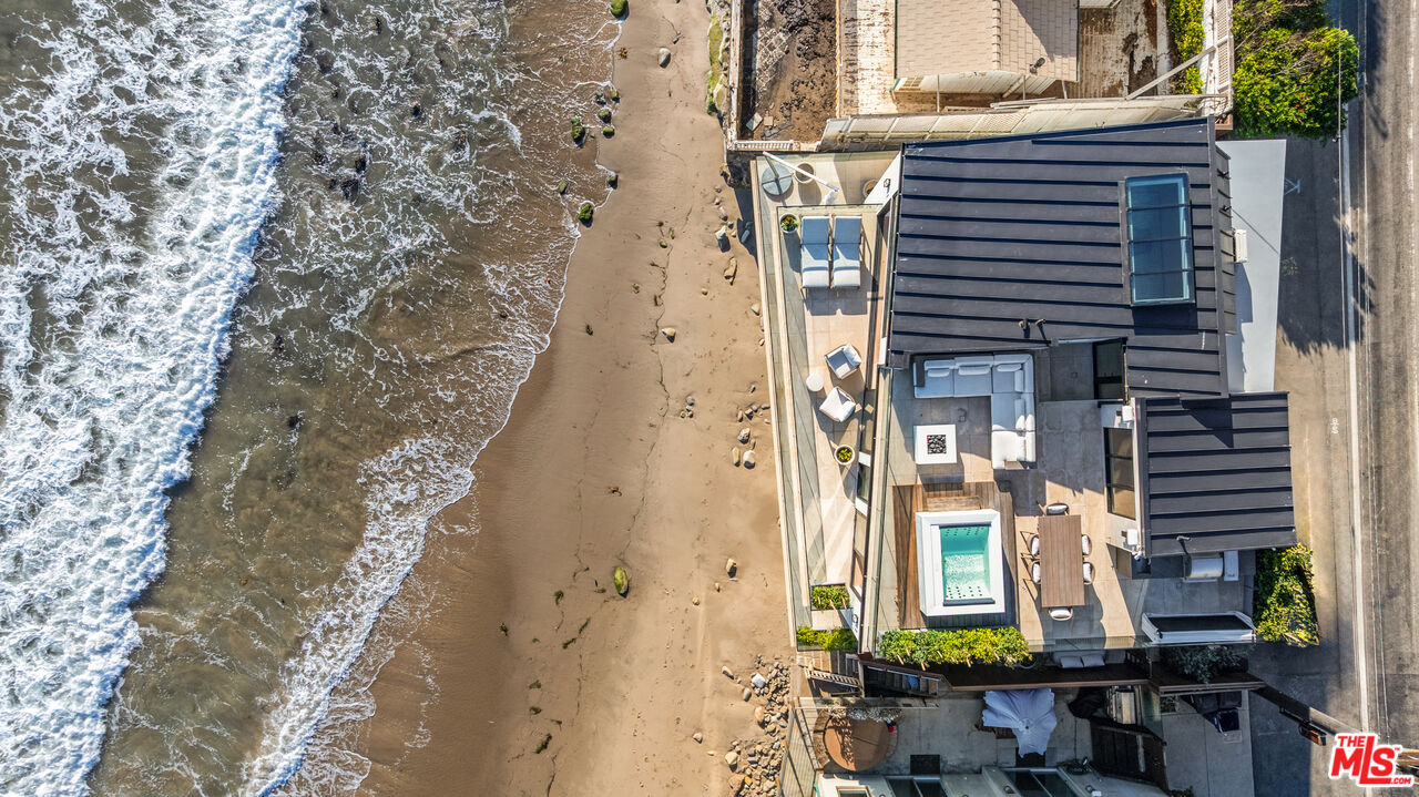 Beachfront home beside the Pacific, with a furnished terrace and small pool.