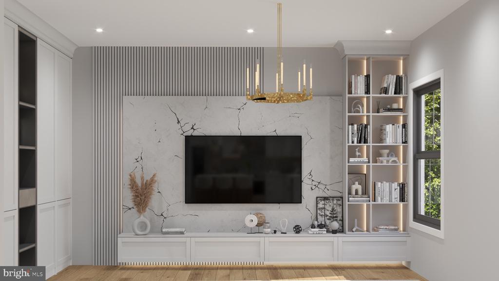 Living room with a marble television wall, built-in shelves, and a gold chandelier.