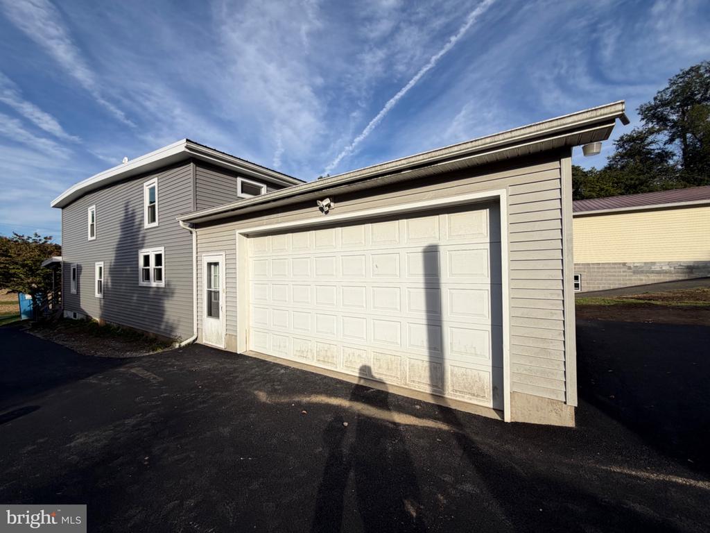 Gray two-story home with a large attached garage and white double garage door.