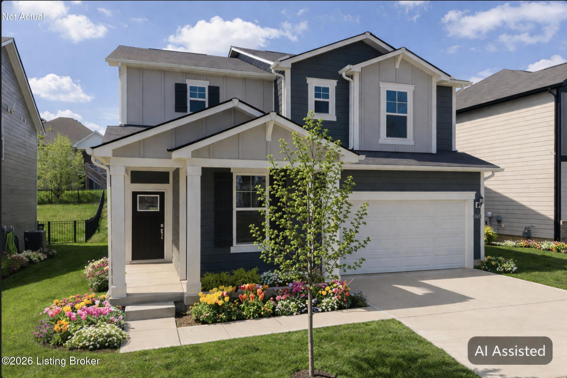 Two-story blue-and-white house with a covered entry, garage, and colorful flower beds.