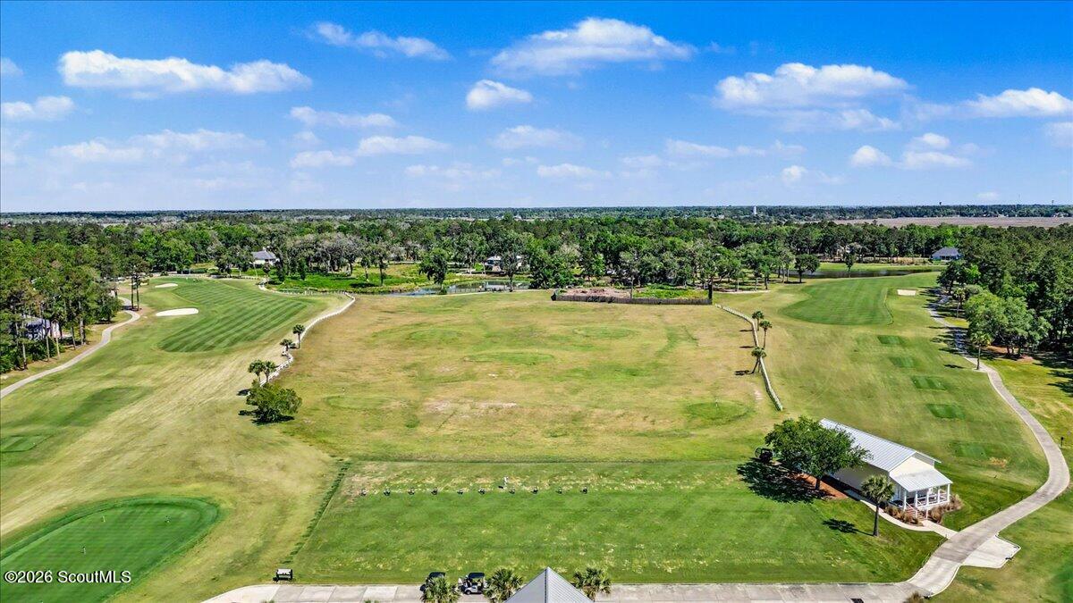 Vacant grassy lot bordered by golf fairways and cart paths.