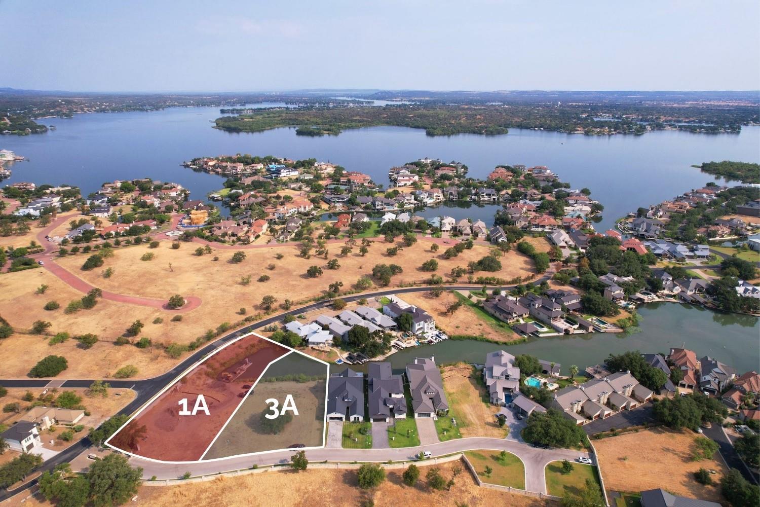 Outlined lots 1A and 3A beside a lake in a residential neighborhood.