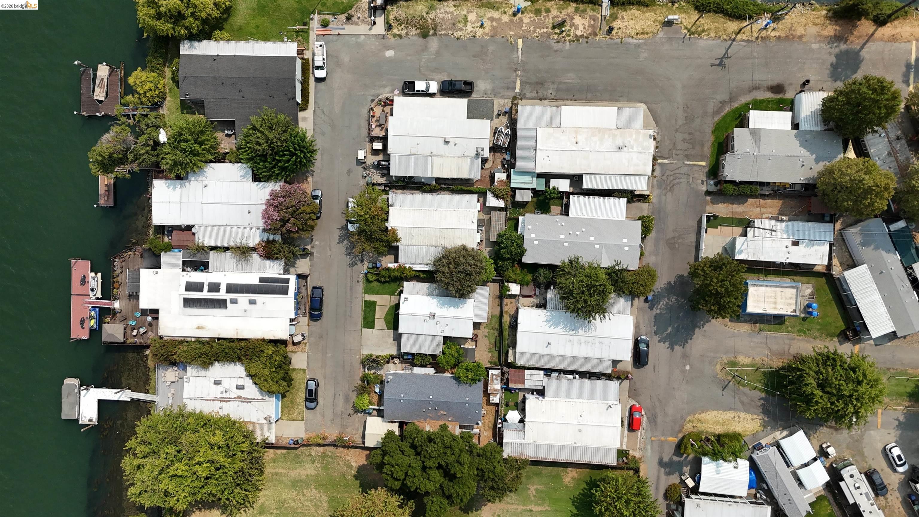 Aerial view of waterfront homes with docks along the shoreline.