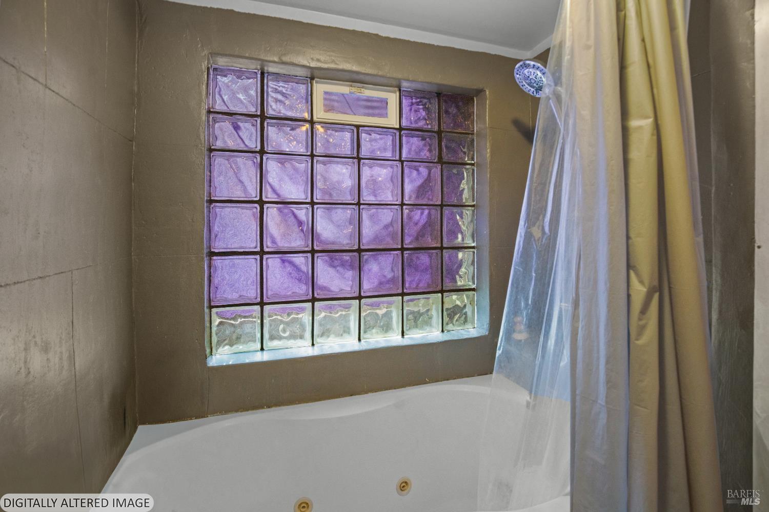 Bathroom with a white tub, shower curtain, and purple glass-block window.
