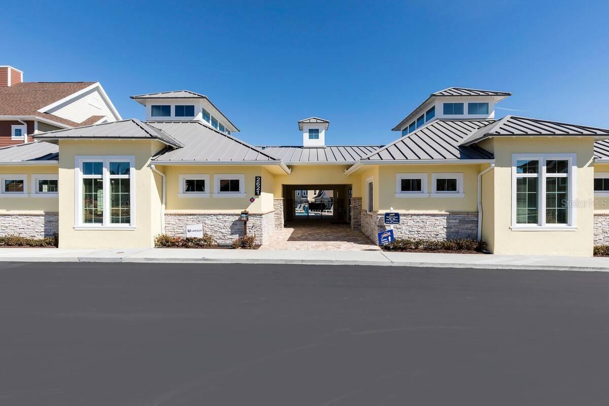 Community building with stone accents and a covered central entrance.