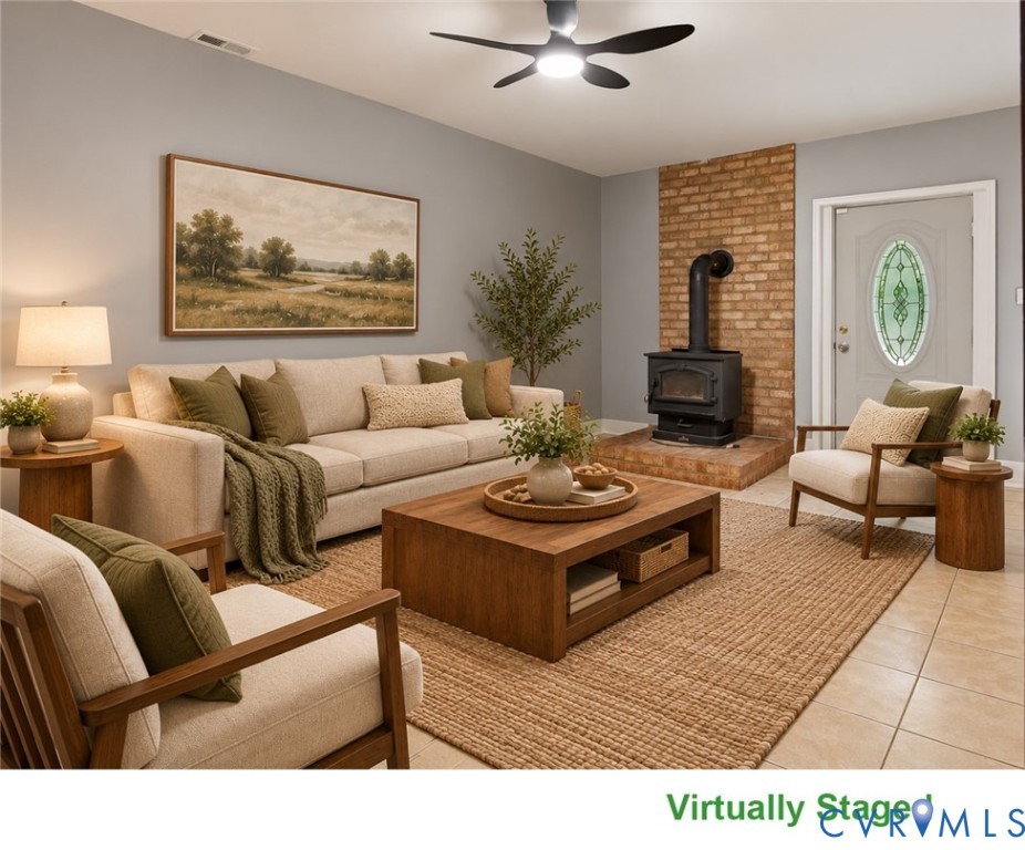 Virtually staged living room with a black wood stove, brick hearth, and beige seating.