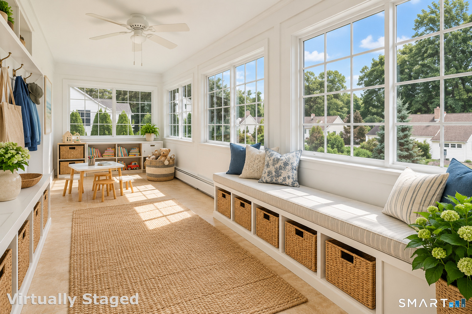 Bright sunroom with a built-in window seat, wicker baskets, and large windows.