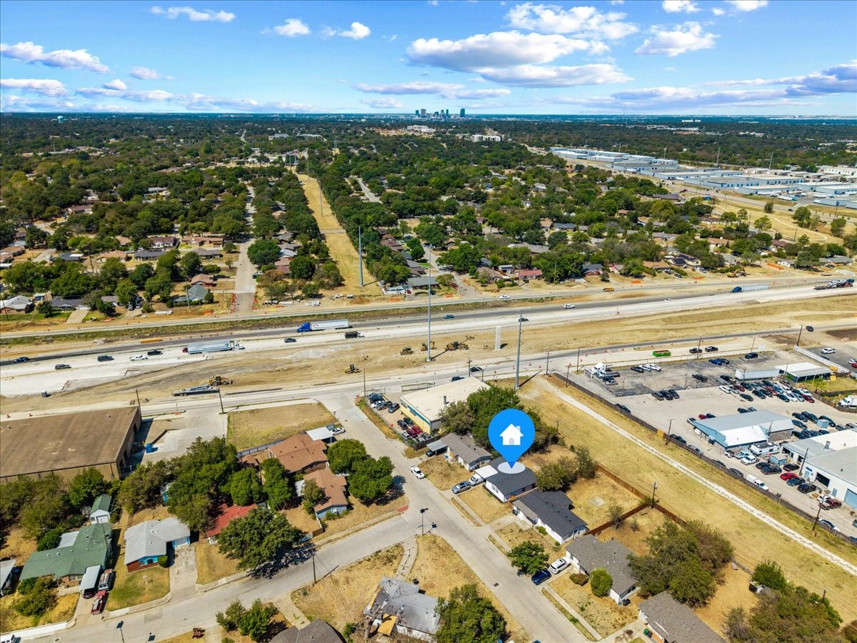 Aerial view of the Truman Drive property, with highway construction in front and the Fort Worth skyline in the distance.