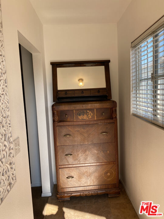 Antique wooden dresser with an attached mirror in a small bedroom at 2643 S Spaulding Avenue.