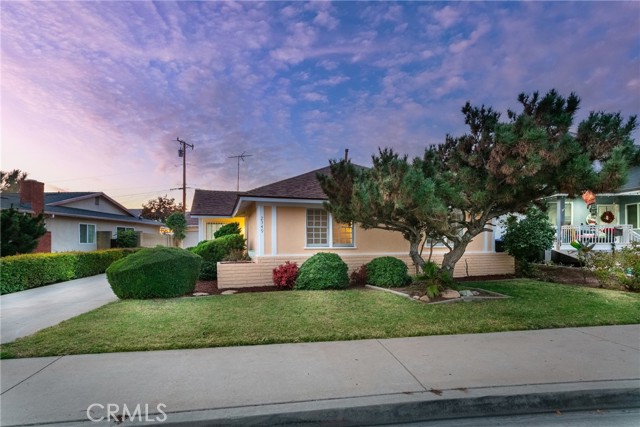 Recently sold single-story Texas home with a landscaped front lawn, mature trees, and a driveway beneath a colorful evening sky.